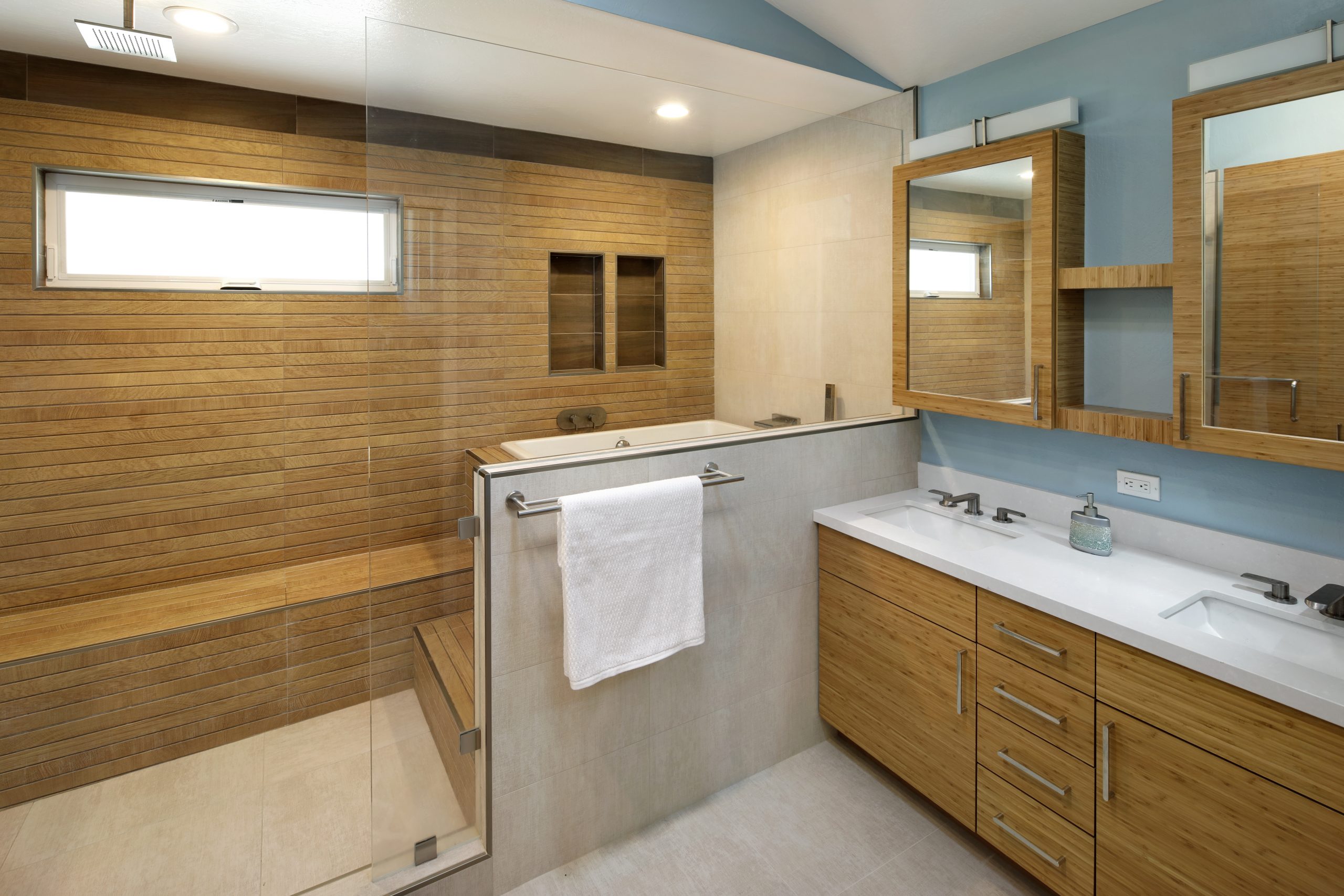 A Japanese style bathroom renovation with wooden shower and tub.