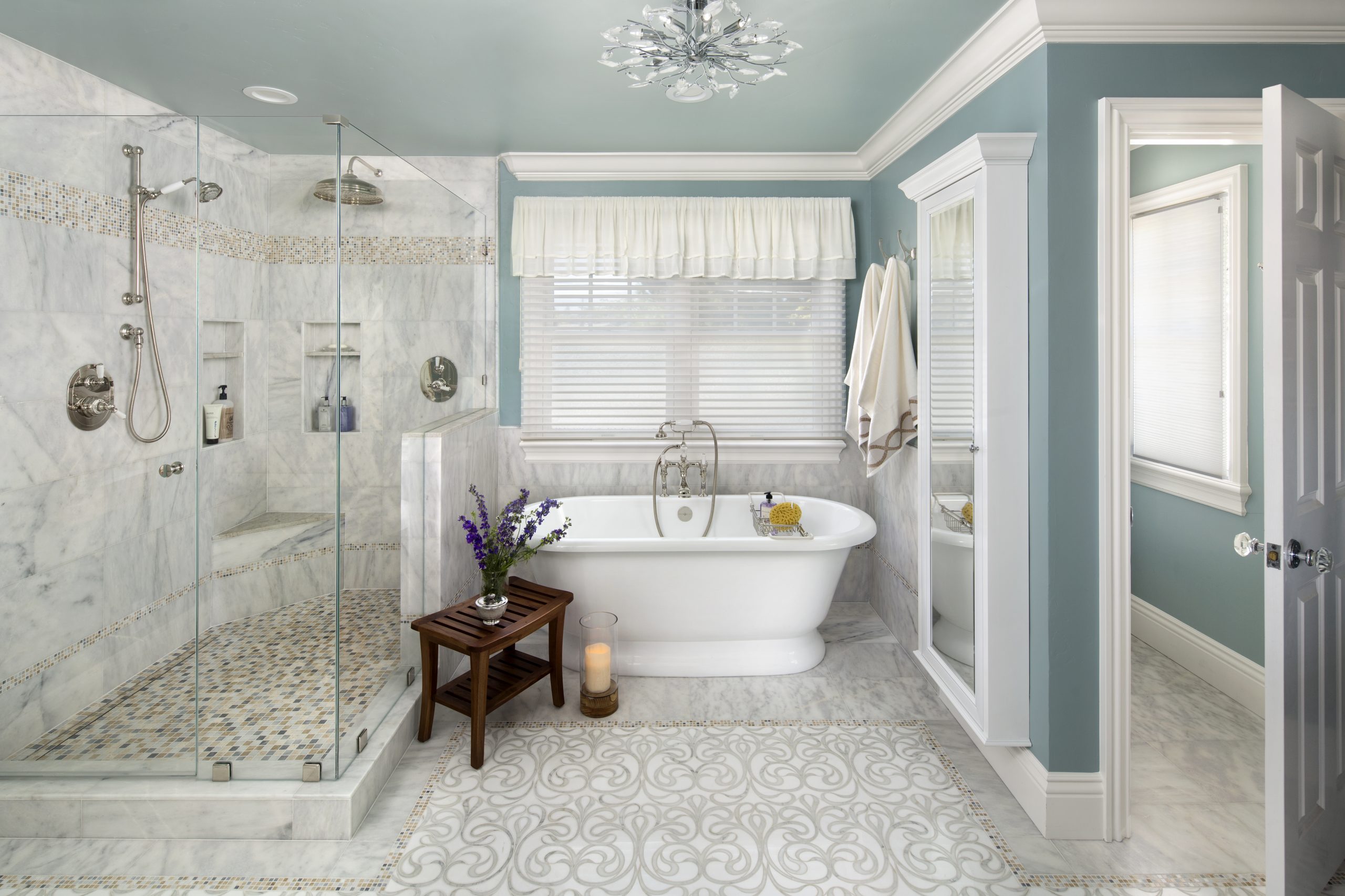 A traditional style bathroom with porcelain tub and glass shower.