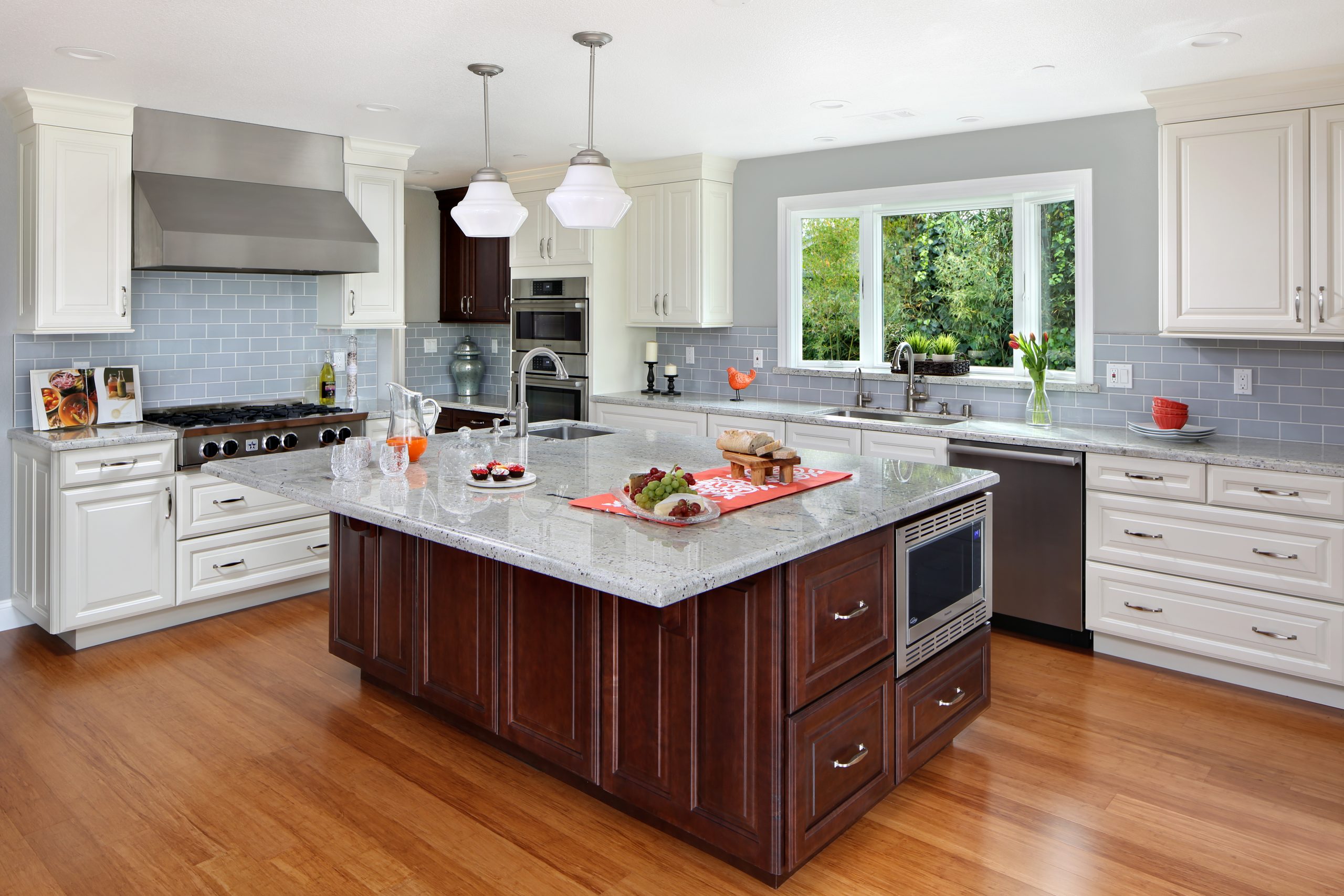 A kitchen with a large center island with granite counter tops.