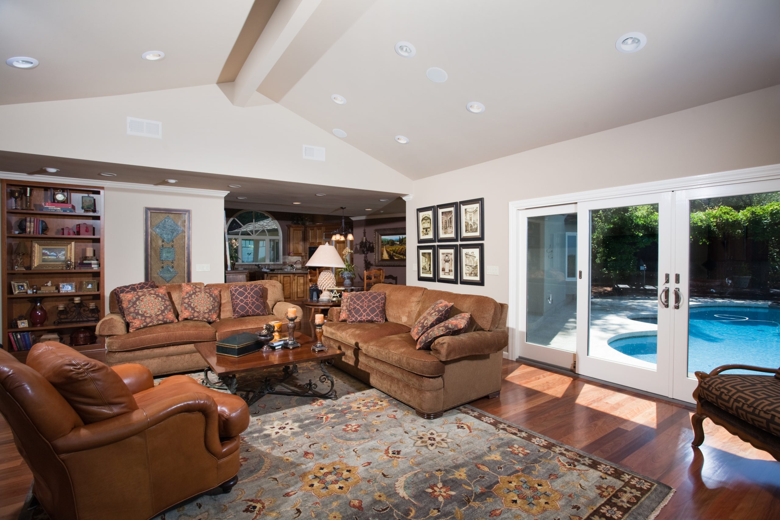 A classic living room with outdoor access to a backyard pool.