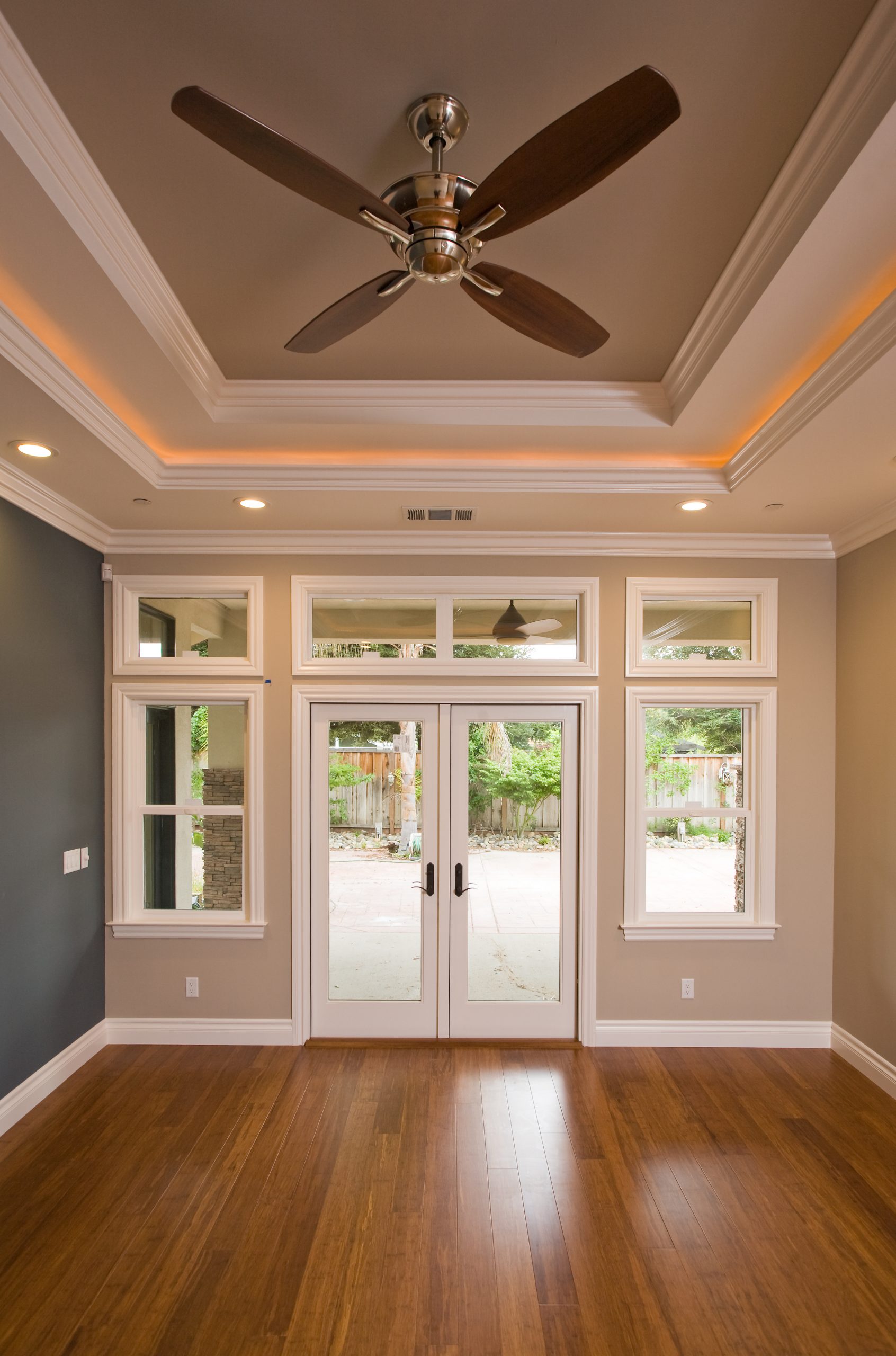 A living room with hardwood floors and recessed ceilings.